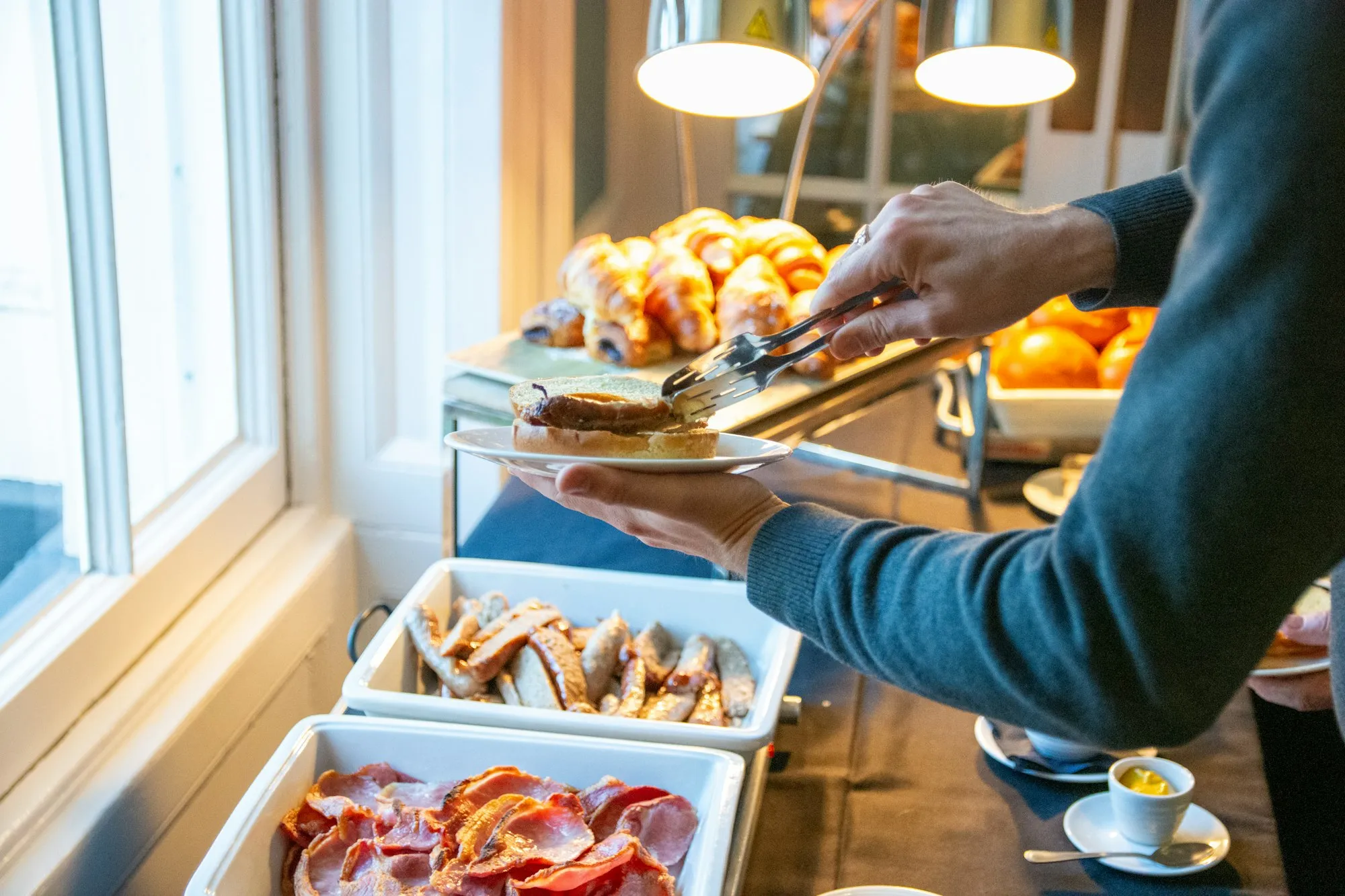 A team member serving the breakfast buffet