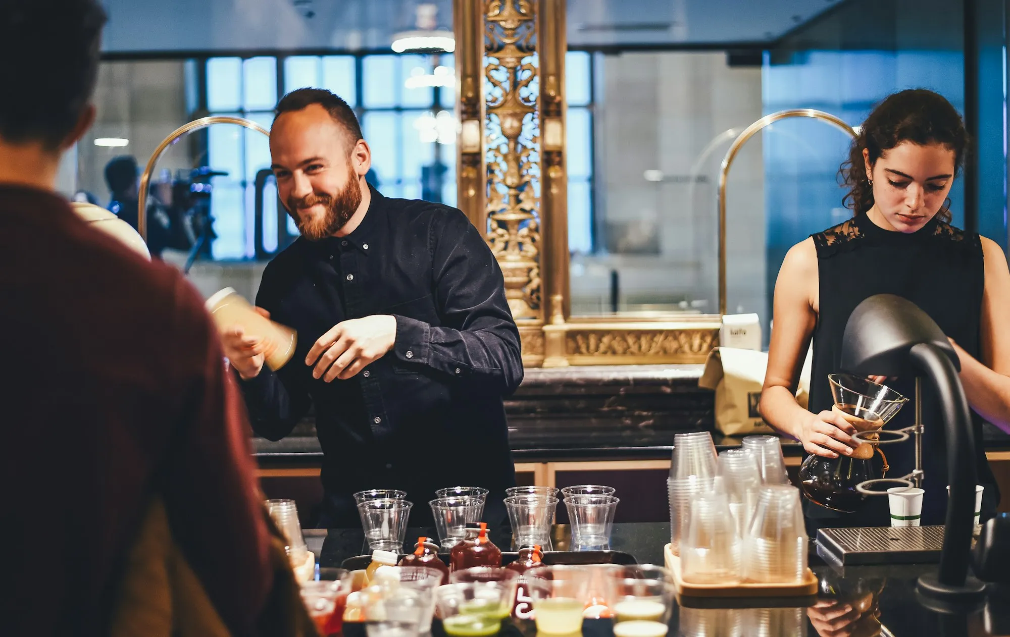 Hotel team members preparing drinks behind the bar
